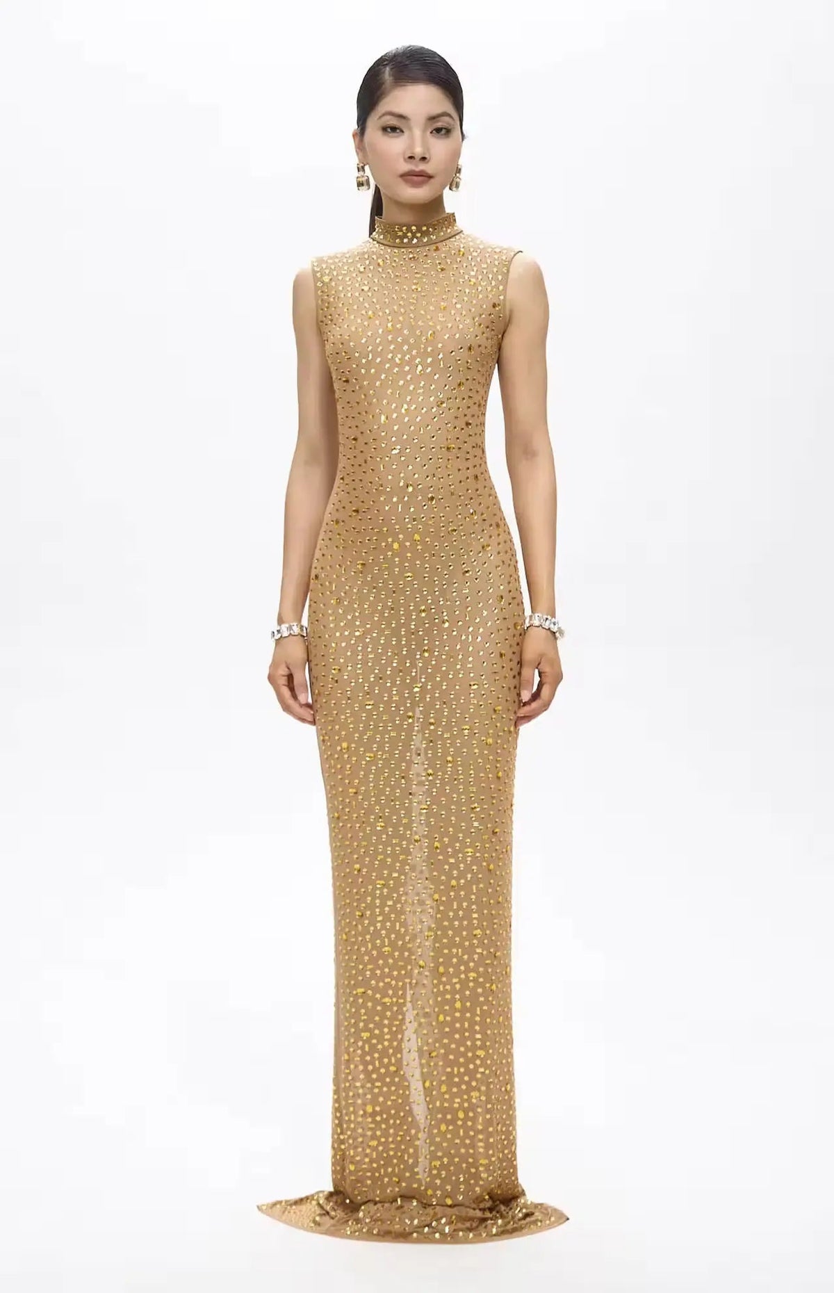 Woman wearing a gold evening gown on a white background