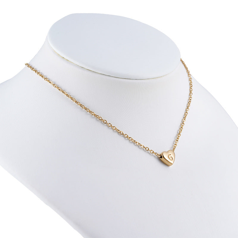 Gold initial necklace worn