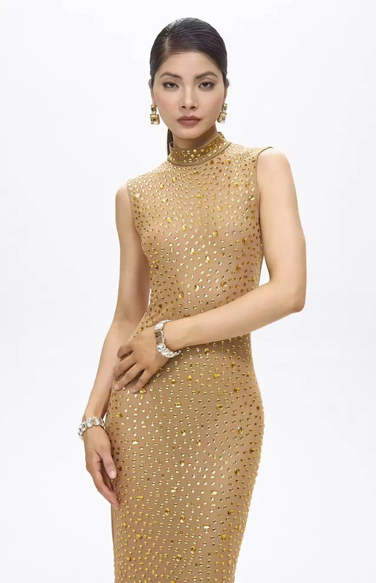 Woman wearing a gold beaded dress on a white background
